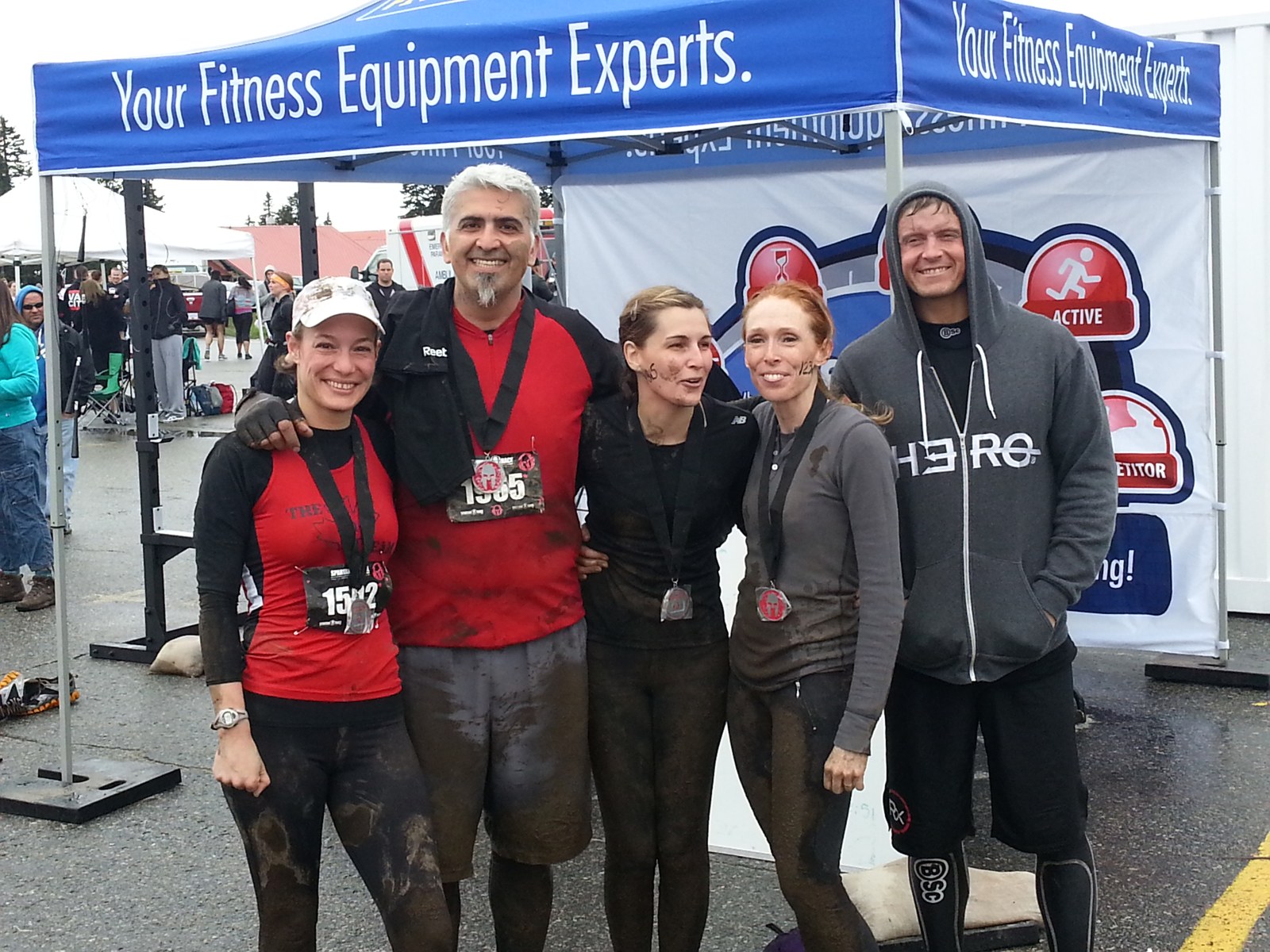 Five participants gathered at a Fitness Town event tent